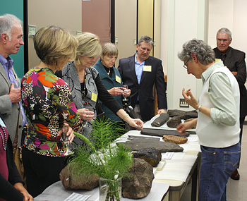 At a donor event in April 2013, Senior Museum Scientist Diane Erwin shows off some of the museum's finest plant fossils from its paleobotanical collection.