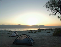 The sun sets on the group's campsite on the shores of the Salton Sea