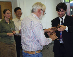 Danny presents his wire sculpture of a Velociraptor to Howard Hutchison