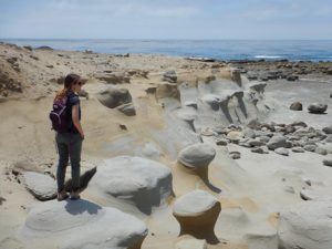 Emily standing on a concretion jutting out just below San Nicolas Island’s youngest marine terrace (~80,000 years old). 