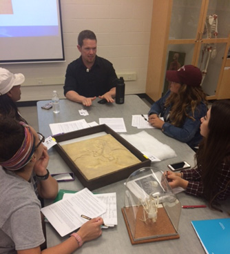 Lecturing on the use of fossils to understand the process of science. Photo courtesy of Briana McCarthy. 