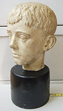 Sculpture of boy's head on black base
