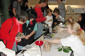 Grad student showing visitors fossil plants