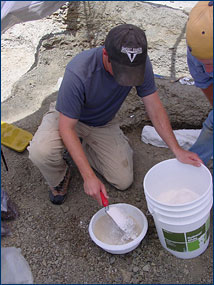 Randy mixes water and plaster