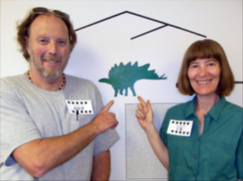 Martin Lockley and Karen Houck pointing to a Stegosaurus (the Colorado State Dinosaur) at the Denver Tracks Museum