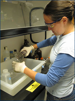 Erin Meyer fills a specimen jar with an ethanol solution