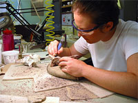 Katie Brakora prepares a fossil using an air scribe