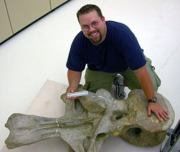 Matt Wedel with an Apatosaurus vertebra