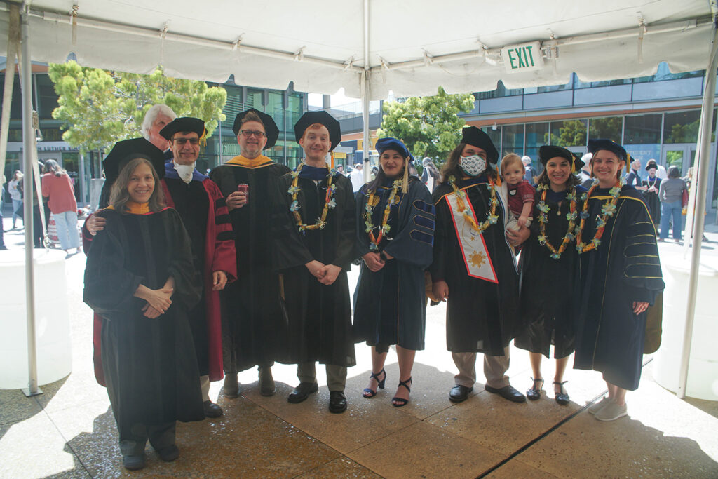 Students and faculty in graduation regalia.